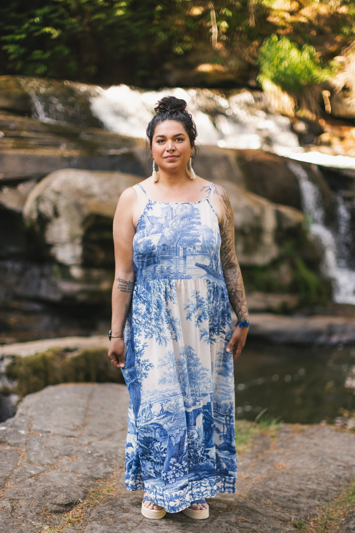 Model wearing Let the Light In bamboo viscose slip dress featuring print of Delft blue and white landscape pottery, and positive message of light and hope - Market of Stars