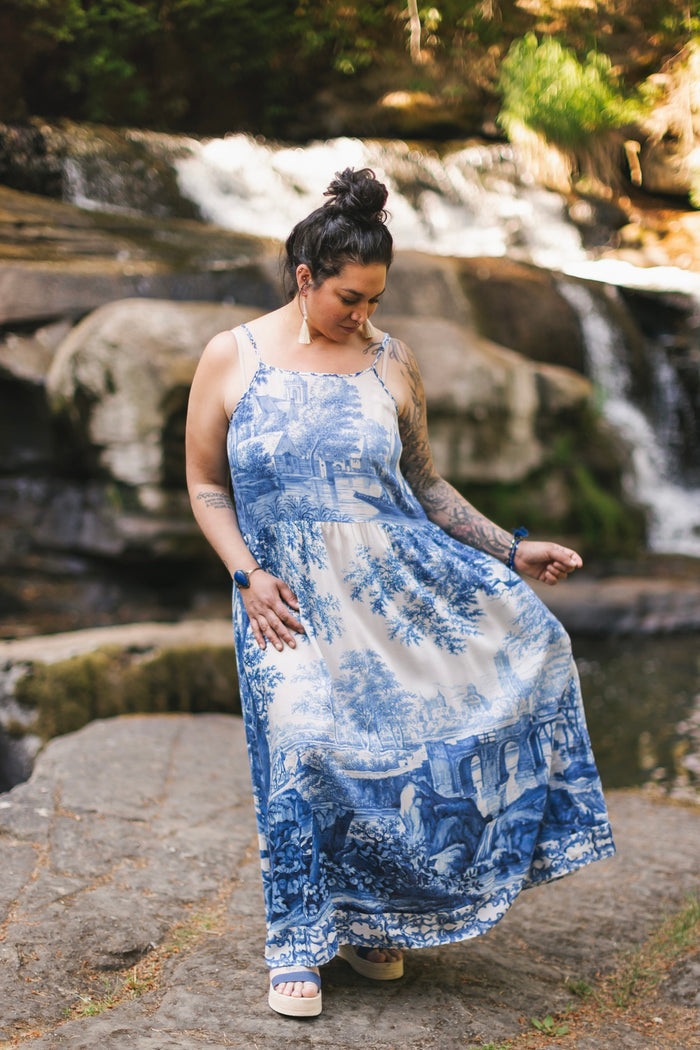 Model wearing Let the Light In bamboo viscose slip dress featuring print of Delft blue and white landscape pottery, and positive message of light and hope - Market of Stars