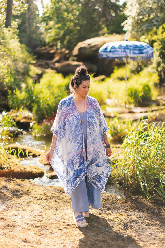 Model wearing Let the Light In Goddess kimono duster featuring print of Delft blue and white landscape pottery, and positive message of light and hope - Market of Stars