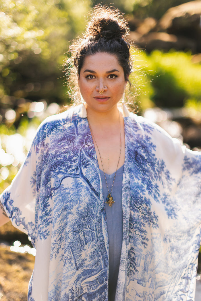 Model wearing Let the Light In Goddess kimono duster featuring print of Delft blue and white landscape pottery, and positive message of light and hope - Market of Stars