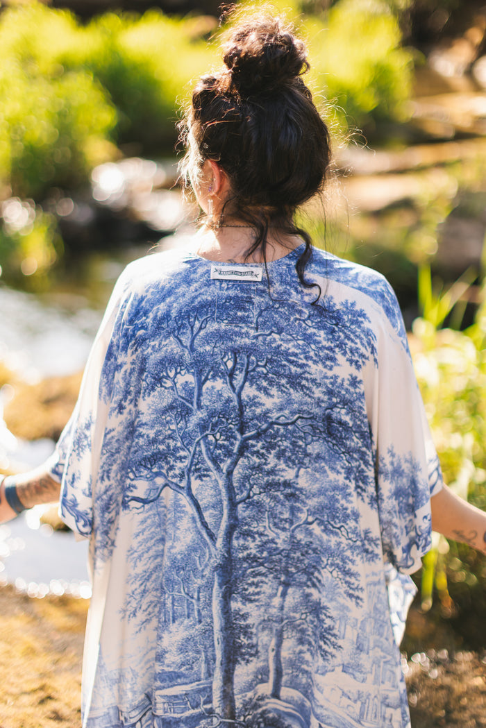 Model wearing Let the Light In Goddess kimono duster featuring print of Delft blue and white landscape pottery, and positive message of light and hope - Market of Stars