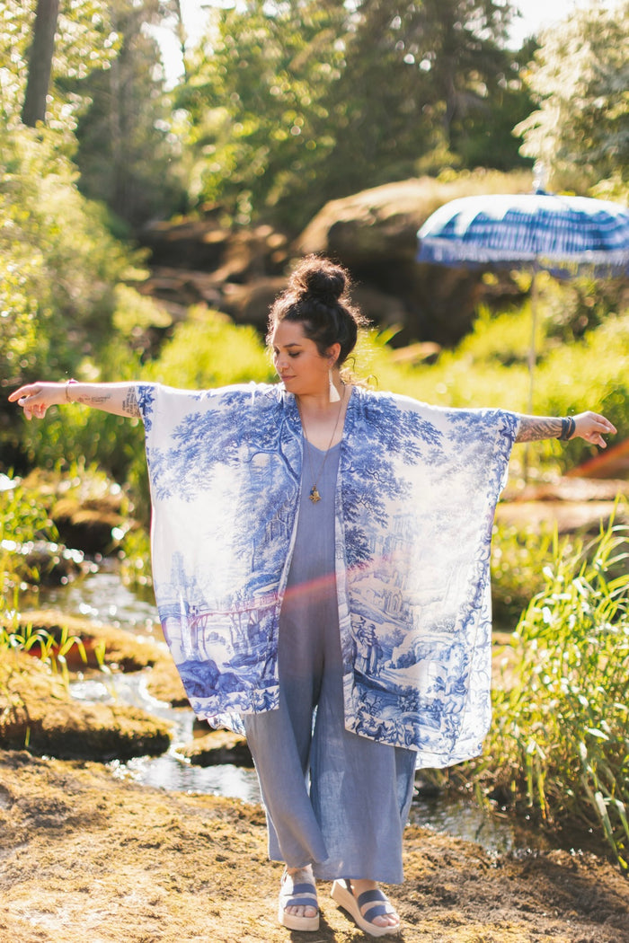Model wearing Let the Light In Goddess kimono duster featuring print of Delft blue and white landscape pottery, and positive message of light and hope - Market of Stars