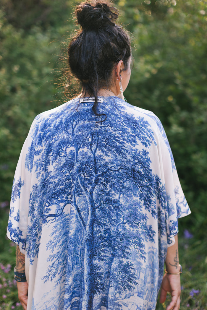 Model wearing Let the Light In Goddess kimono duster featuring print of Delft blue and white landscape pottery, and positive message of light and hope - Market of Stars