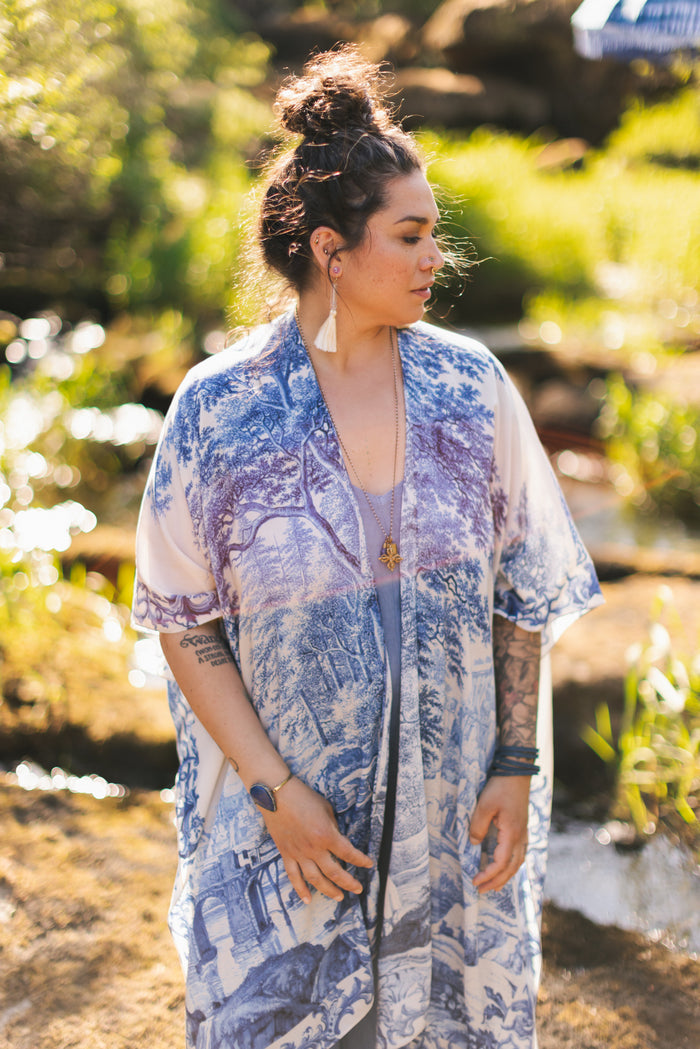 Model wearing Let the Light In Goddess kimono duster featuring print of Delft blue and white landscape pottery, and positive message of light and hope - Market of Stars