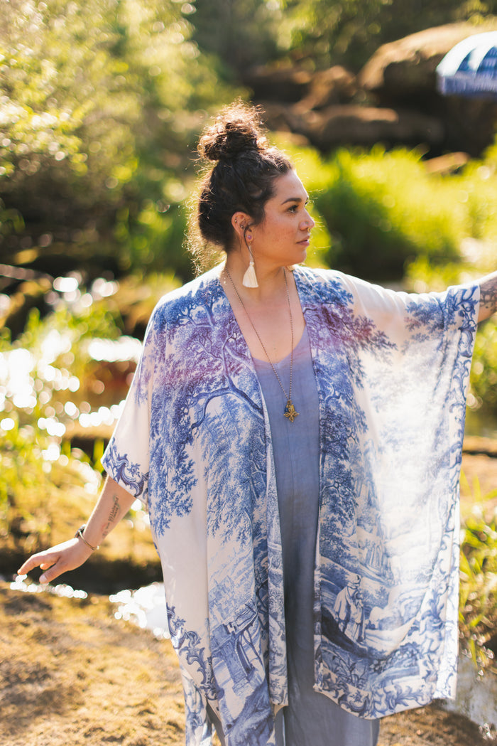 Model wearing Let the Light In Goddess kimono duster featuring print of Delft blue and white landscape pottery, and positive message of light and hope - Market of Stars