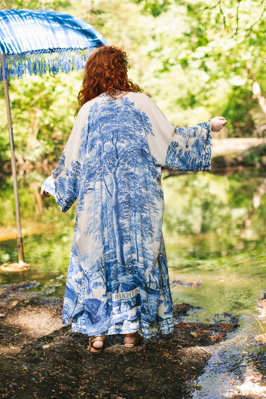 Model wearing Let the Light In long opera duster kimono featuring print of Delft blue and white landscape pottery, and positive message of light and hope - Market of Stars