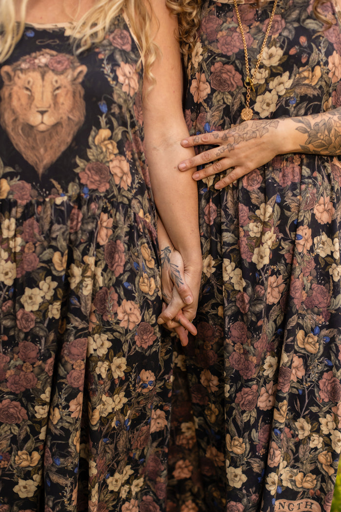 Model wearing a maxi-length slip dress in a floral print ft. artwork by artist & illustrator Jessica Roux - Market of Stars