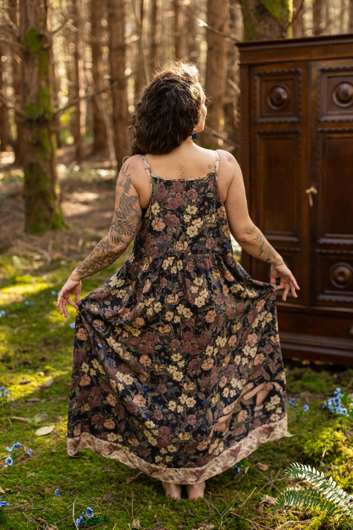 Model wearing a maxi-length slip dress in a floral print ft. artwork by artist & illustrator Jessica Roux - Market of Stars