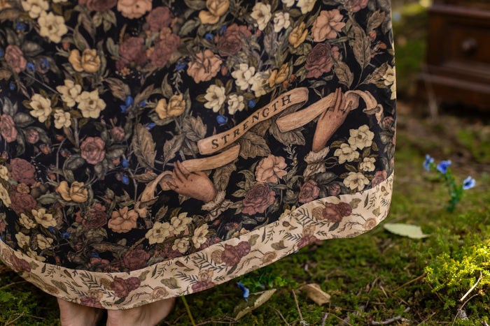 Model wearing a maxi-length slip dress in a floral print ft. artwork by artist & illustrator Jessica Roux - Market of Stars