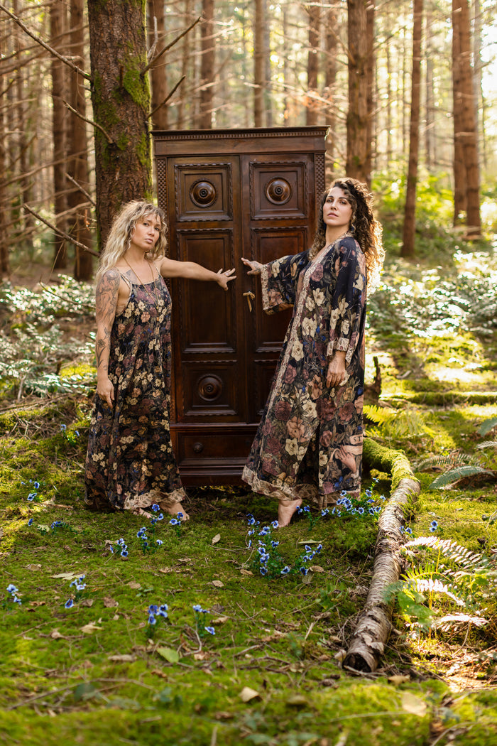 Model wearing a maxi-length slip dress in a floral print ft. artwork by artist & illustrator Jessica Roux - Market of Stars