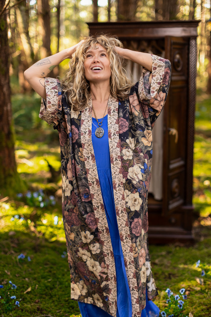 Model wearing a full-length floral duster ft. artwork by artist & illustrator Jessica Roux - Market of Stars