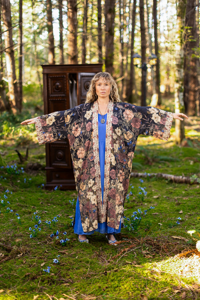 Model wearing a full-length floral duster ft. artwork by artist & illustrator Jessica Roux - Market of Stars