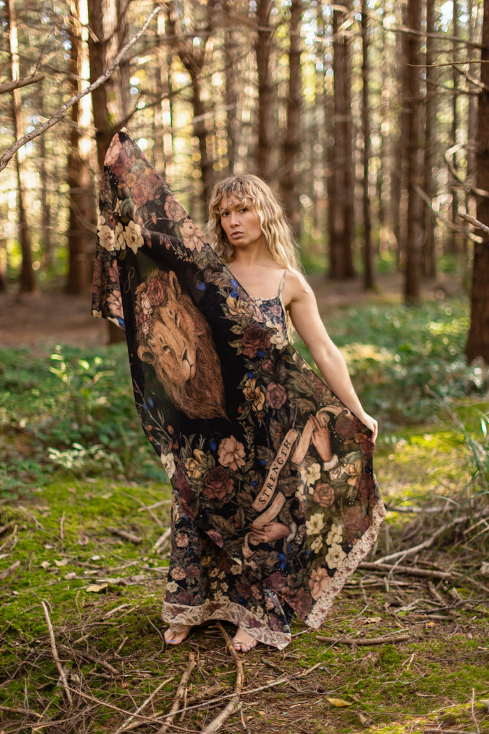 Model wearing a bamboo viscose scarf ft. artwork by artist & illustrator Jessica Roux - Market of Stars