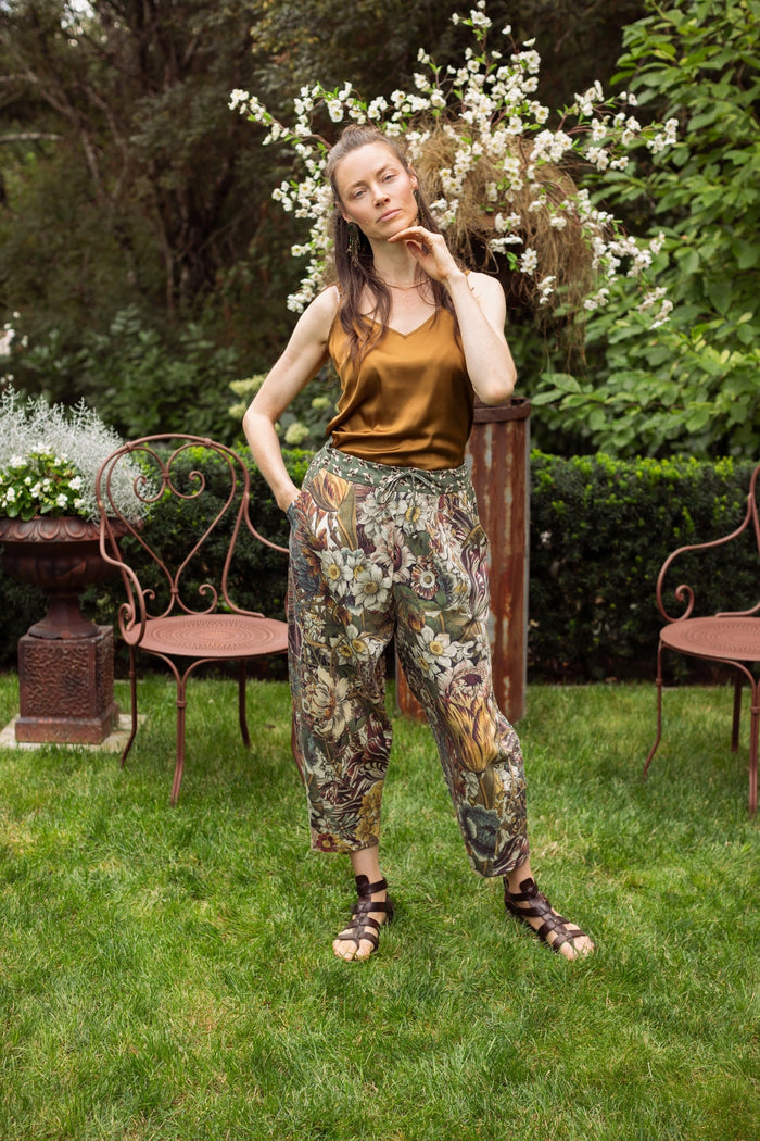 Model styled in Love Grows Wild Artist Pants featuring 1700s hand-coloured floral etchings and bumblebee trim – relaxed lantern hem and cropped fit – Market of Stars