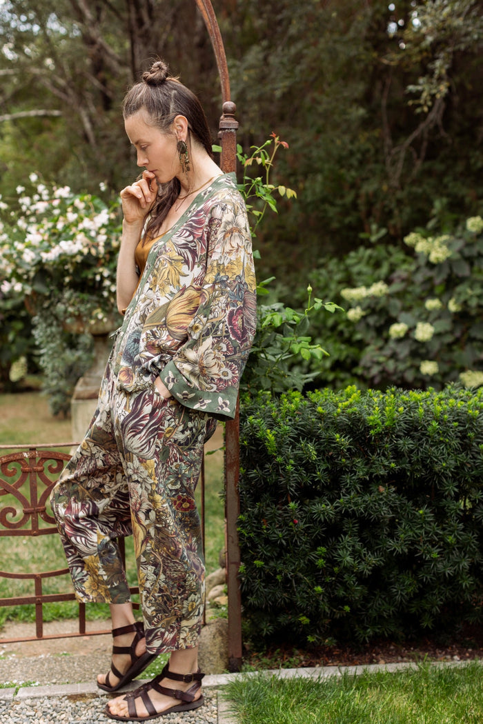 Model styled in Love Grows Wild Artist Pants featuring 1700s hand-coloured floral etchings and bumblebee trim – relaxed lantern hem and cropped fit – Market of Stars