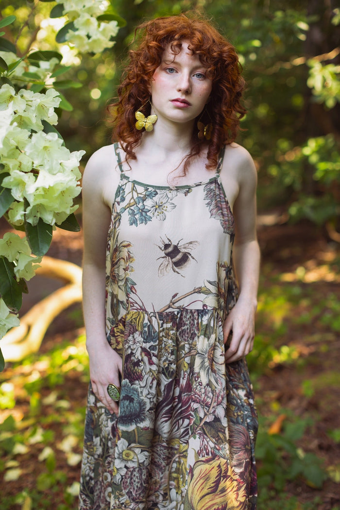 Model wearing Love Grows Wild Bohéme Slip Dress featuring hand-coloured 1700s botanical etchings and bumblebee detail – adjustable, flowy, and reversible – Market of Stars.