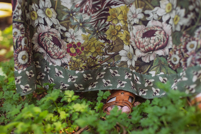 Model wearing Love Grows Wild Bohéme Slip Dress featuring hand-coloured 1700s botanical etchings and bumblebee detail – adjustable, flowy, and reversible – Market of Stars.
