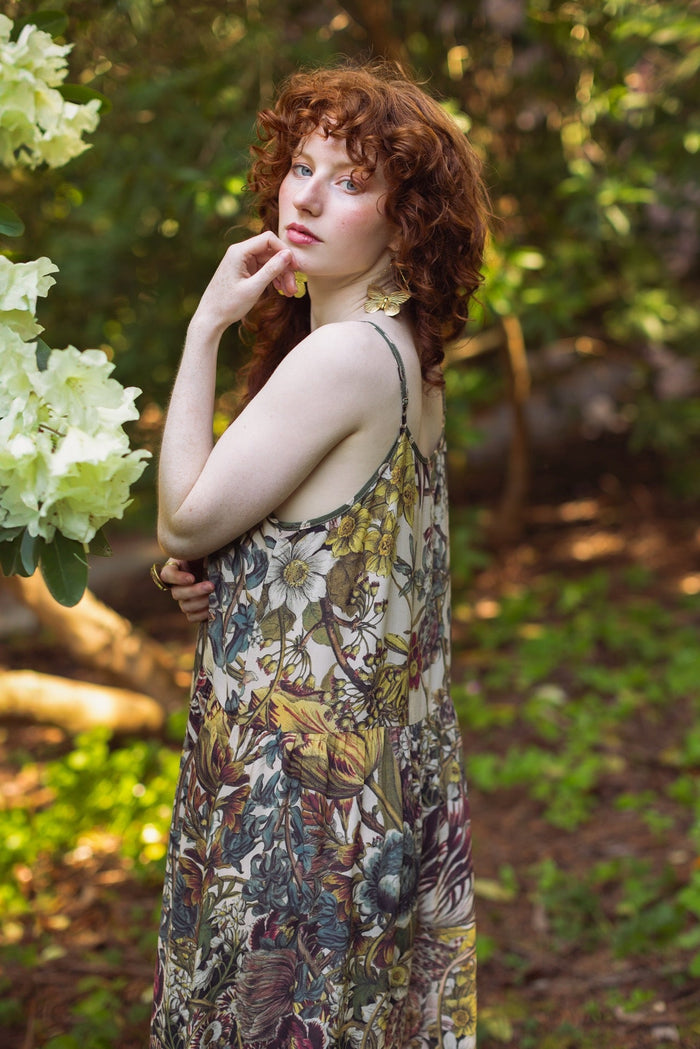Model wearing Love Grows Wild Bohéme Slip Dress featuring hand-coloured 1700s botanical etchings and bumblebee detail – adjustable, flowy, and reversible – Market of Stars.