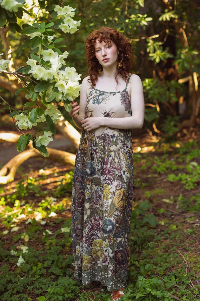 Model wearing Love Grows Wild Bohéme Slip Dress featuring hand-coloured 1700s botanical etchings and bumblebee detail – adjustable, flowy, and reversible – Market of Stars.