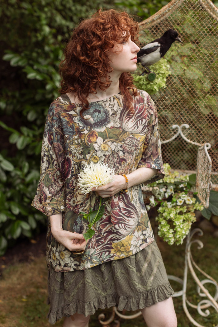 Model wearing the Love Grows Wild Luxe Tee featuring lush floral etchings inspired by 1700s botanical art with hidden bee trim detail – Market of Stars.