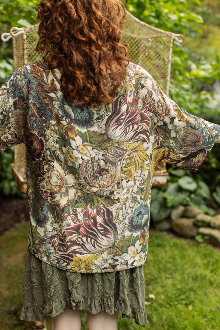 Model wearing the Love Grows Wild Luxe Tee featuring lush floral etchings inspired by 1700s botanical art with hidden bee trim detail – Market of Stars.