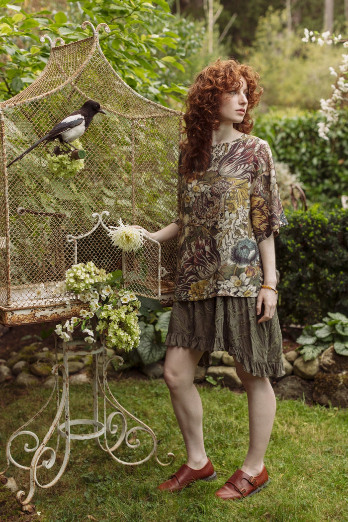 Model wearing the Love Grows Wild Luxe Tee featuring lush floral etchings inspired by 1700s botanical art with hidden bee trim detail – Market of Stars.