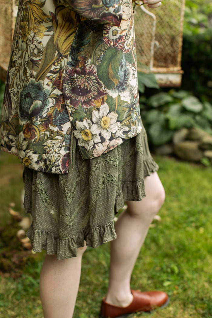 Model wearing the Love Grows Wild Luxe Tee featuring lush floral etchings inspired by 1700s botanical art with hidden bee trim detail – Market of Stars.