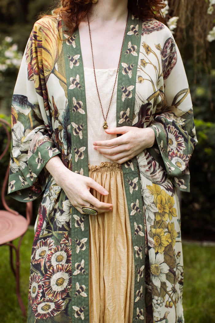 Model wearing kimono featuring 1700s March floral etchings and charming bumblebee trim inspired by vintage seed catalogues – Market of Stars.