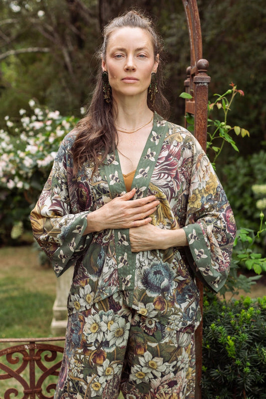 Model wearing Love Grows Wild Pixie Duster featuring hand-coloured 1700s floral etchings and charming bumblebee trim, celebrating the joy of abundance – Market of Stars.