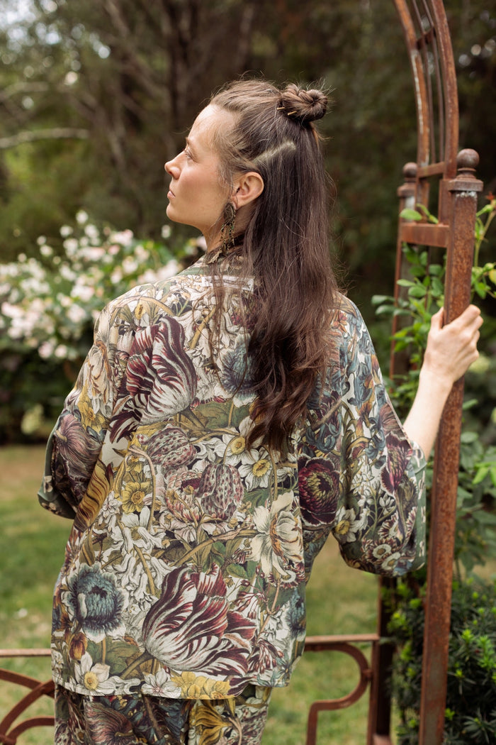 Model wearing Love Grows Wild Pixie Duster featuring hand-coloured 1700s floral etchings and charming bumblebee trim, celebrating the joy of abundance – Market of Stars.