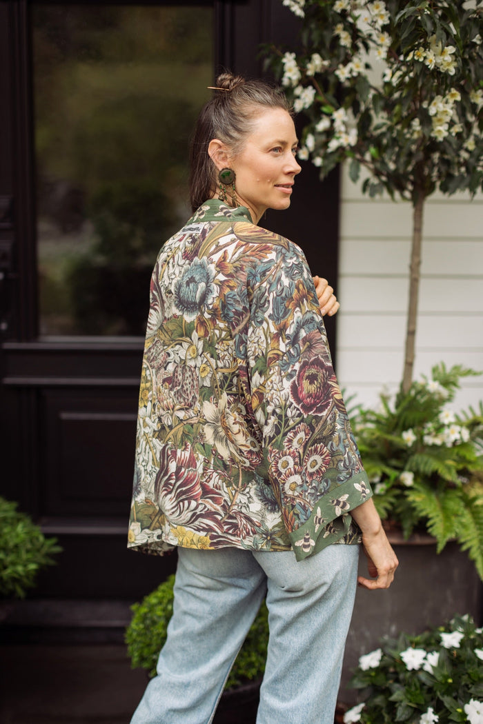 Model wearing Love Grows Wild Pixie Duster featuring hand-coloured 1700s floral etchings and charming bumblebee trim, celebrating the joy of abundance – Market of Stars.