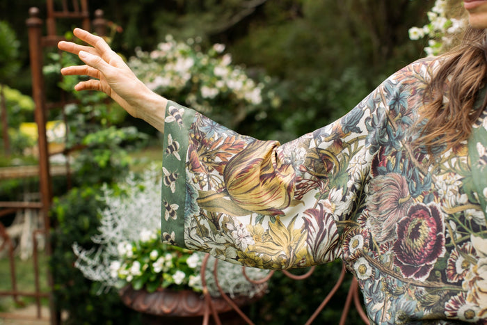 Model wearing Love Grows Wild Pixie Duster featuring hand-coloured 1700s floral etchings and charming bumblebee trim, celebrating the joy of abundance – Market of Stars.