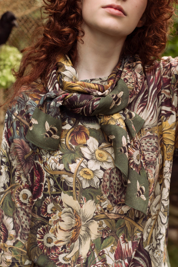 Model wearing soft viscose scarf featuring 1700s March botanical etchings and bumblebee trim from vintage seed catalogue – Market of Stars.