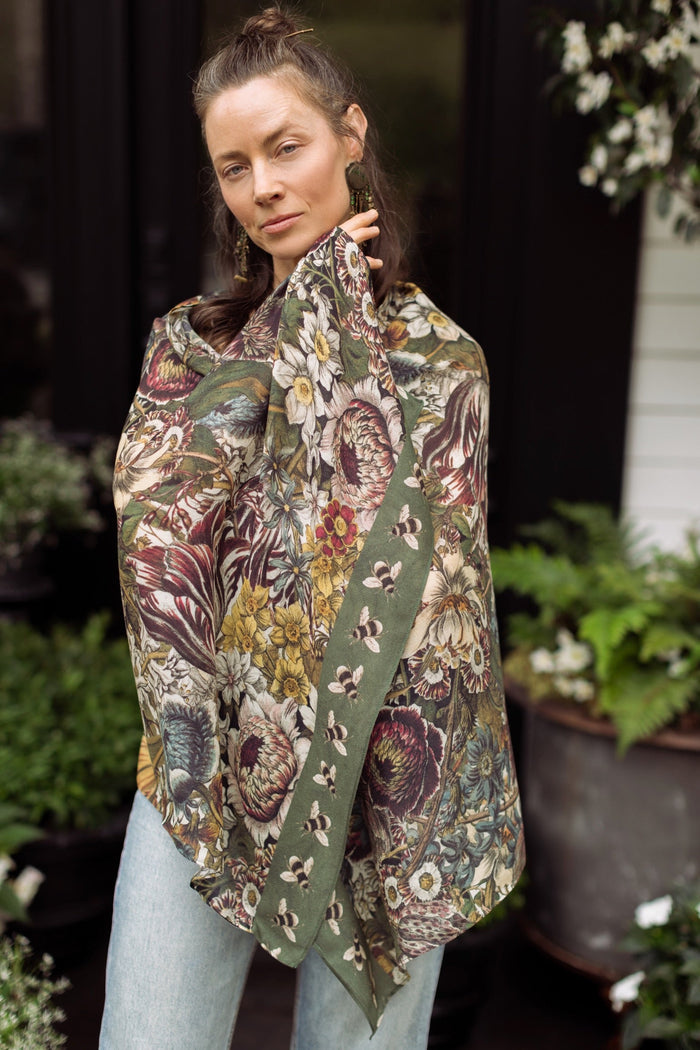 Model wearing soft viscose scarf featuring 1700s March botanical etchings and bumblebee trim from vintage seed catalogue – Market of Stars.