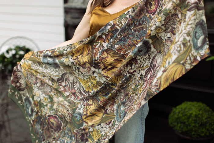 Model wearing soft viscose scarf featuring 1700s March botanical etchings and bumblebee trim from vintage seed catalogue – Market of Stars.