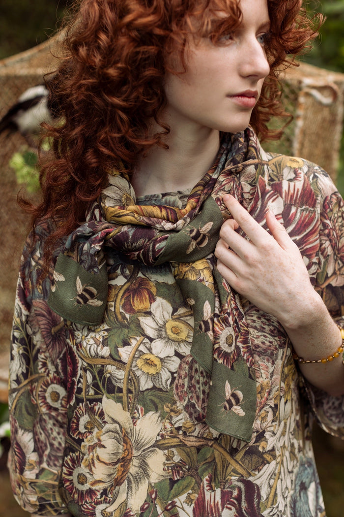 Model wearing soft viscose scarf featuring 1700s March botanical etchings and bumblebee trim from vintage seed catalogue – Market of Stars.