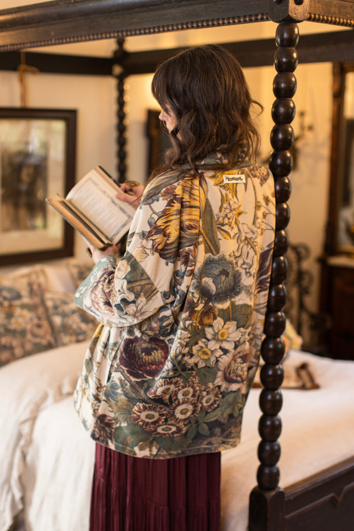 Model wearing a soft cotton velvet duster featuring lush 1700s botanical blooms and bumblebee trim - Market of Stars