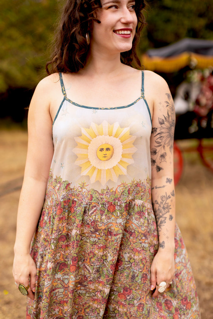 Model wearing a maxi-length slip dress ft. a woman astride a rearing horse, soft vintage florals, rosettes and lithographs from the 1800's - Market of Stars