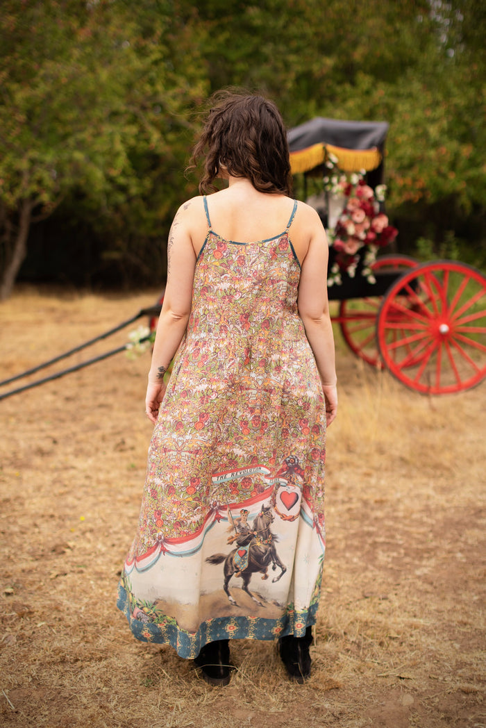 Model wearing a maxi-length slip dress ft. a woman astride a rearing horse, soft vintage florals, rosettes and lithographs from the 1800's - Market of Stars
