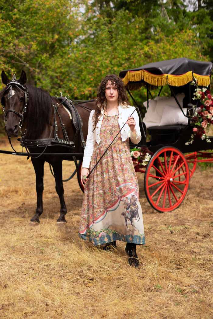 Model wearing a maxi-length slip dress ft. a woman astride a rearing horse, soft vintage florals, rosettes and lithographs from the 1800's - Market of Stars