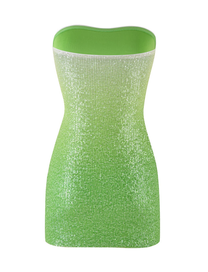 The LYKA DRESS - GREEN : OMBRE : SEQUIN by TIGERMIST is a strapless, shimmering dress with a form-fitting silhouette. Its fabric features a glittery texture that sparkles as it catches the light, and it transitions from a pale green at the top to a brighter green at the bottom.