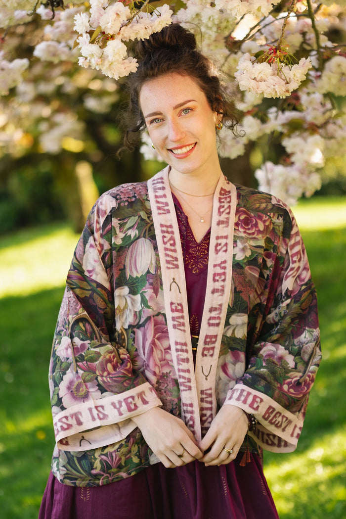 Model wearing cropped kimono featuring gold wishbone–vintage coin–evening star–dandelion–and spring floral collage with “Make a wish” banner – Market of Stars