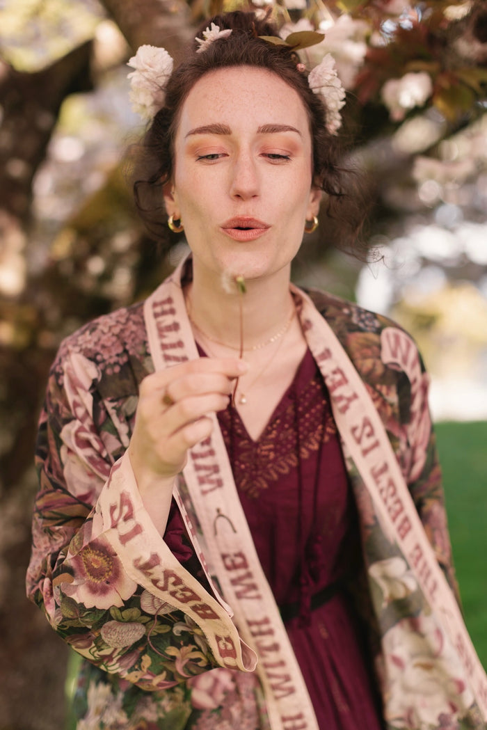 Model wearing cropped kimono featuring gold wishbone–vintage coin–evening star–dandelion–and spring floral collage with “Make a wish” banner – Market of Stars