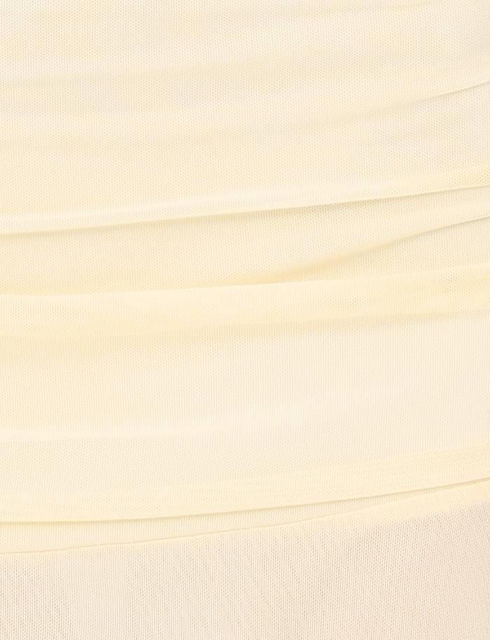 Close-up of the TIGERMIST MARIANA SKIRT in pale yellow, featuring soft mesh fabric with horizontal gathered folds and a textured surface—lightweight and perfect for an airy midi style with subtle shading and lines.