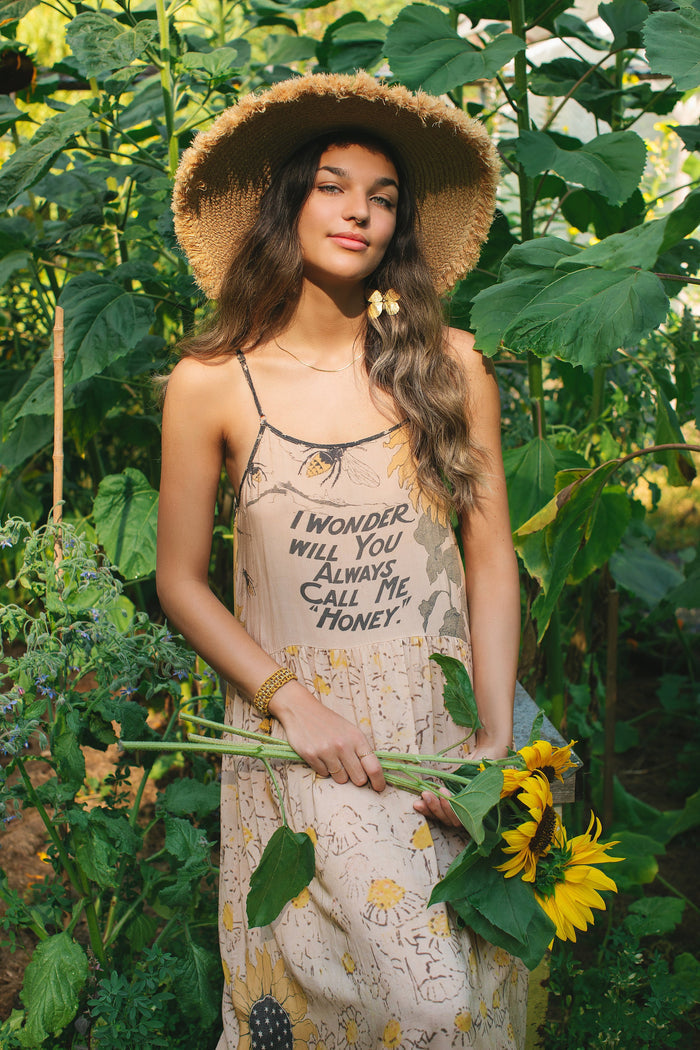 Model wearing the Milk & Honey Bohéme Slip Dress featuring nostalgic 1904 Brooklyn artwork, vintage woodcut stars, and Hoytema’s antique floral print – Market of Stars.