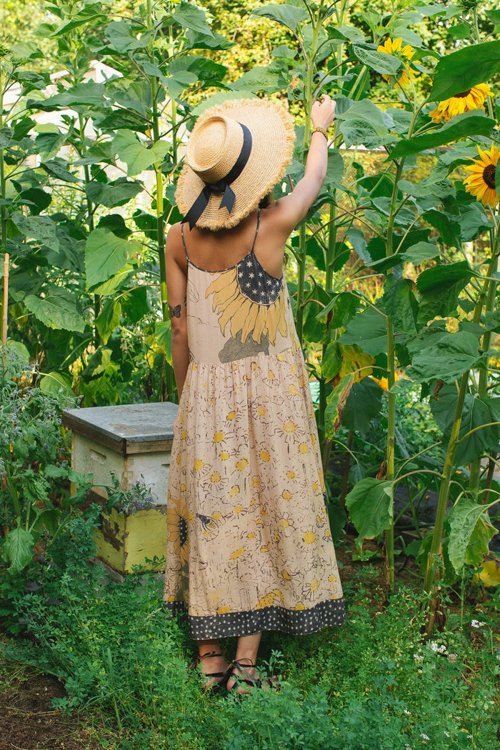 Model wearing the Milk & Honey Bohéme Slip Dress featuring nostalgic 1904 Brooklyn artwork, vintage woodcut stars, and Hoytema’s antique floral print – Market of Stars.