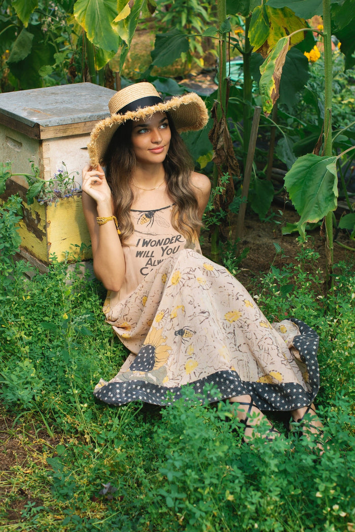 Model wearing the Milk & Honey Bohéme Slip Dress featuring nostalgic 1904 Brooklyn artwork, vintage woodcut stars, and Hoytema’s antique floral print – Market of Stars.