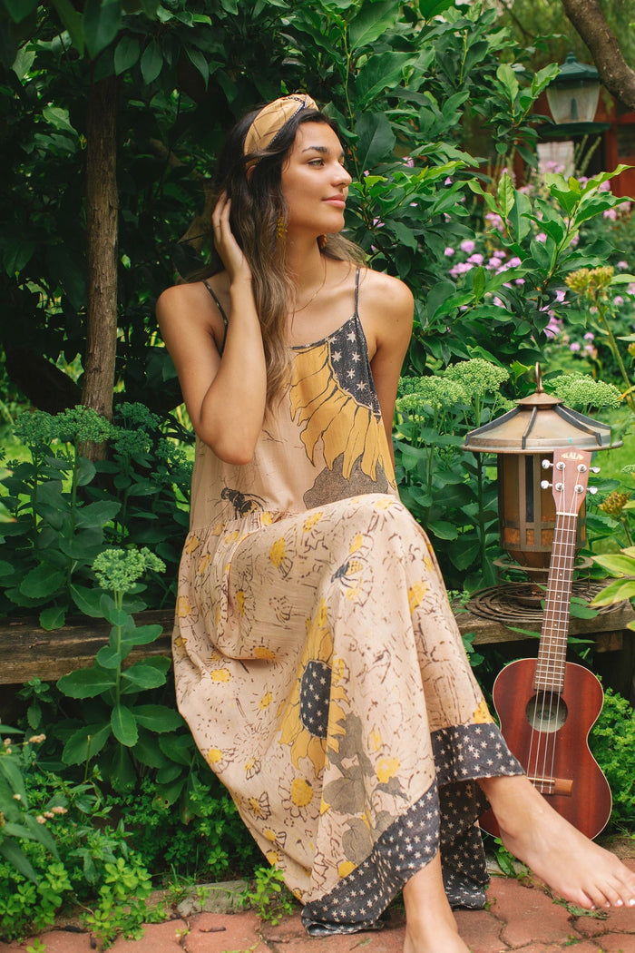 Model wearing the Milk & Honey Bohéme Slip Dress featuring nostalgic 1904 Brooklyn artwork, vintage woodcut stars, and Hoytema’s antique floral print – Market of Stars.