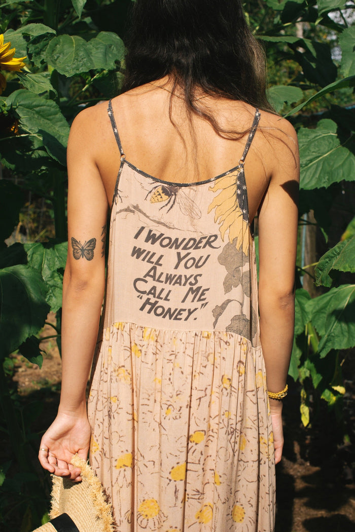Model wearing the Milk & Honey Bohéme Slip Dress featuring nostalgic 1904 Brooklyn artwork, vintage woodcut stars, and Hoytema’s antique floral print – Market of Stars.
