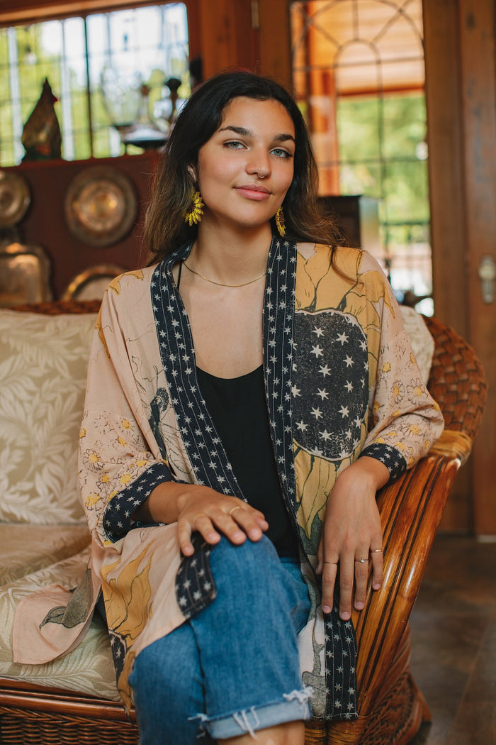 Model wearing our matinee length kimono featuring vintage-inspired Milk & Honey print with 1904 typography and floral woodcuts – Market of Stars